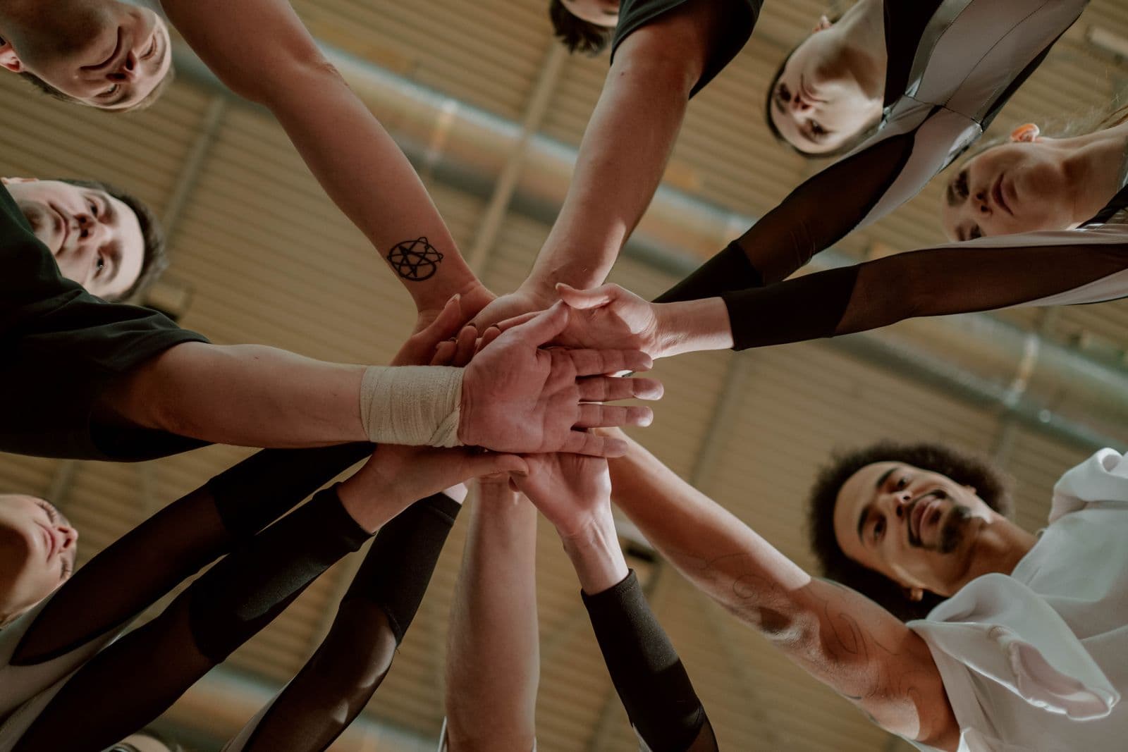 A diverse group joining hands in community