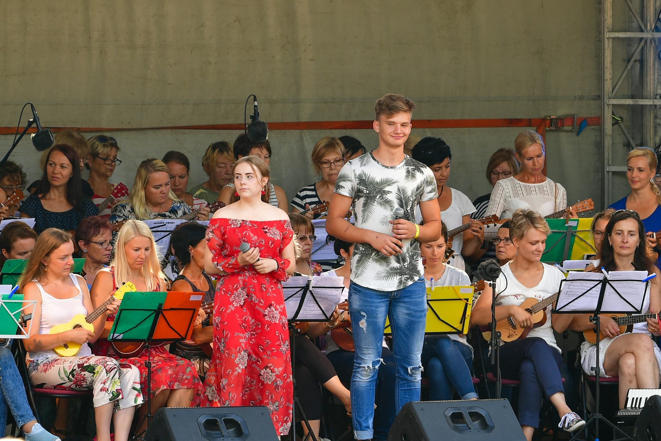 Young singers preparing to perform with a community orchestra